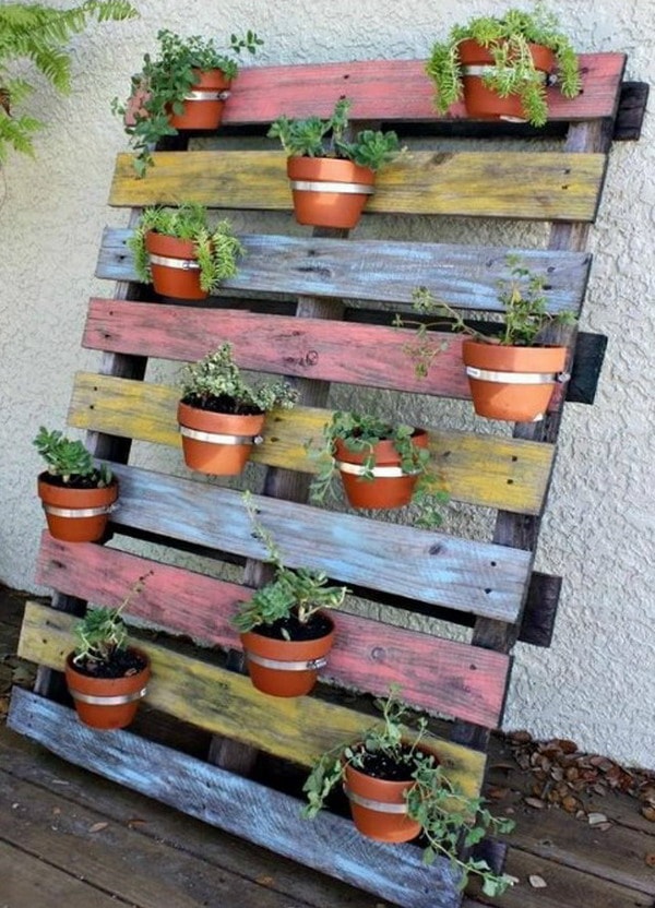 Pots hanging from wooden pallets
