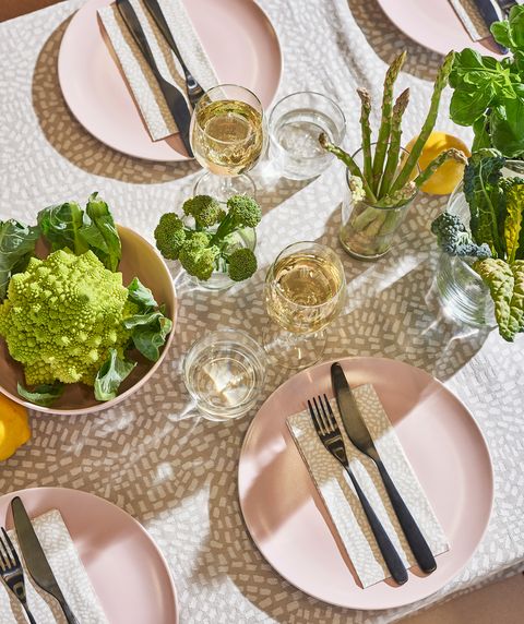 tableware with pink plates and beige tablecloth with dots
