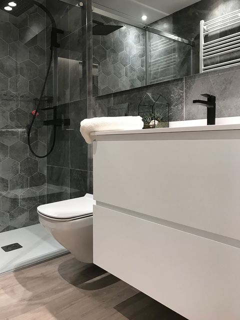 bathroom with shower and floating washbasin unit in white