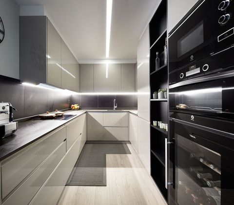 modern design kitchen with lacquered furniture in grey tones