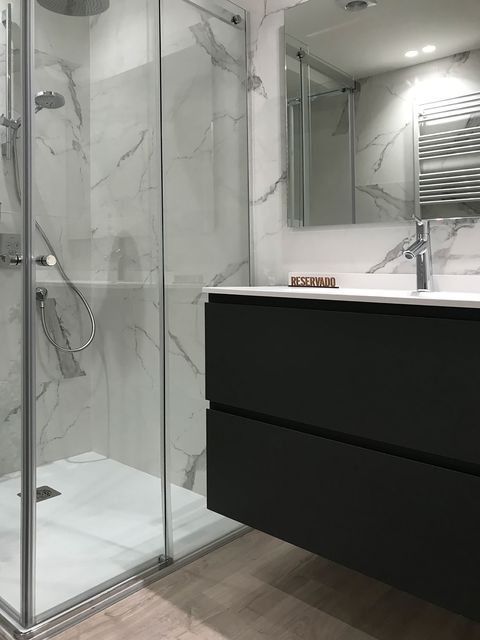 bathroom with a built in shower and a black floating washbasin unit