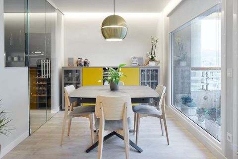 modern design dining room with wooden table and chairs and golden ceiling lamp