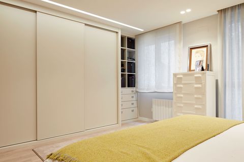 walk-in wardrobe with sliding doors in white