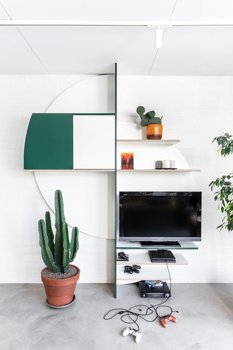 open shelves in white and green with space for the TV