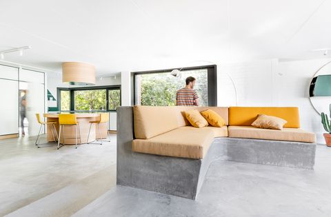 living room open to the kitchen with concrete floor and sofa structure