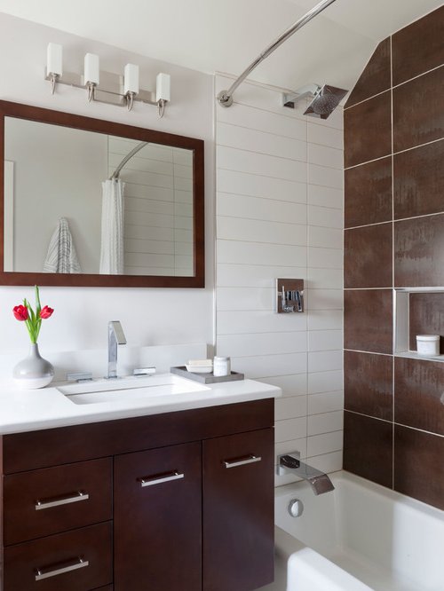 Bathroom with white walls and ceiling, shower wall in dark brown to create depth