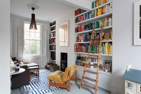 living room with built-in library and open shelves in white