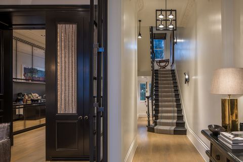 entrance to the kitchen and view of the classic style staircase
