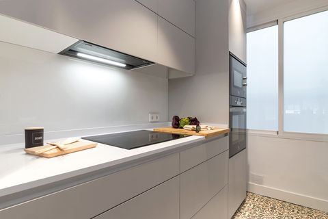 modern kitchen with handleless grey cabinets and ceramic glass