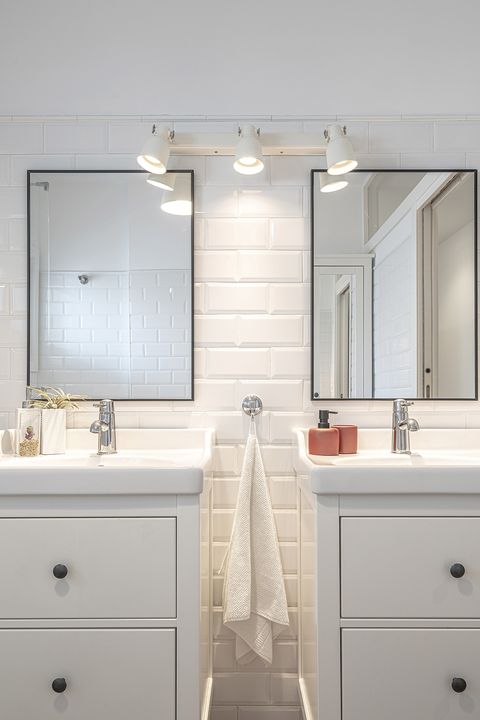 white floor and modern bathroom with two sinks and meter type tiles