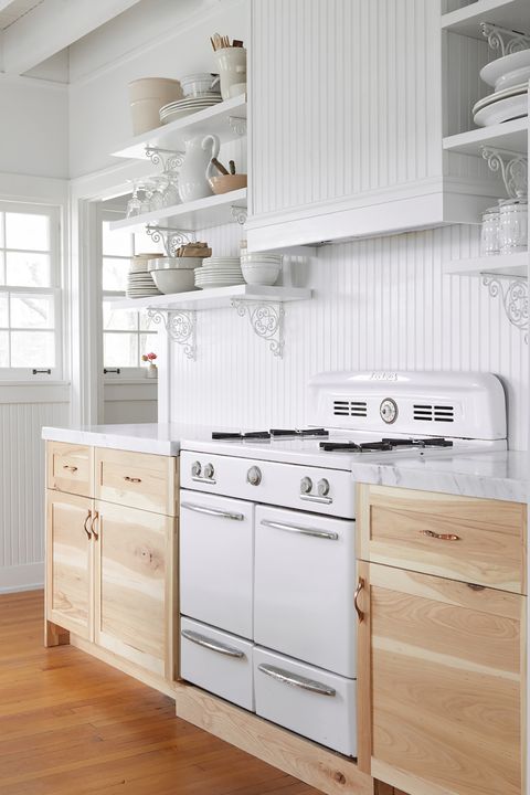 chic farmhouse style kitchen decorated in white with wooden cabinets and marble countertops