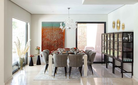 contemporary designed dining room in neutral tones decorated with a tapestry