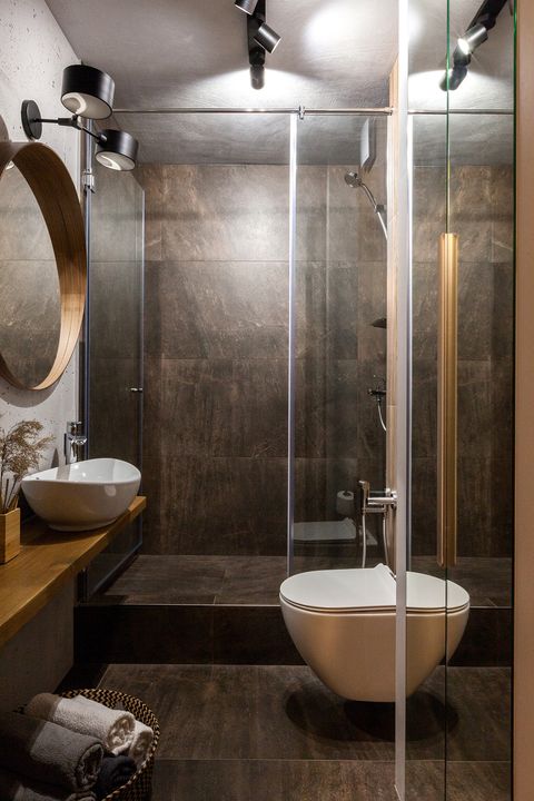 bathroom with shower built in stone and floating wooden countertop