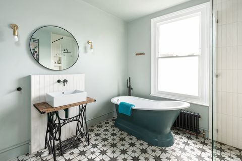 vintage bathroom with antique sewing machine, classic freestanding bathtub and hydraulic tile floor