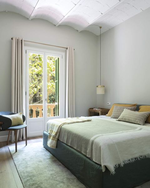 renovated apartment in barcelona master bedroom in green tones