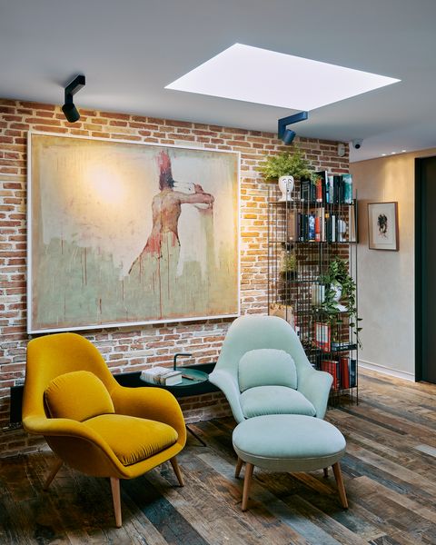 industrial style reading nook with two velvet armchairs