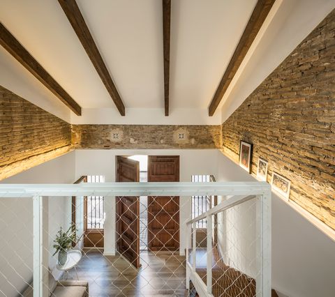 double height room with exposed wooden beams