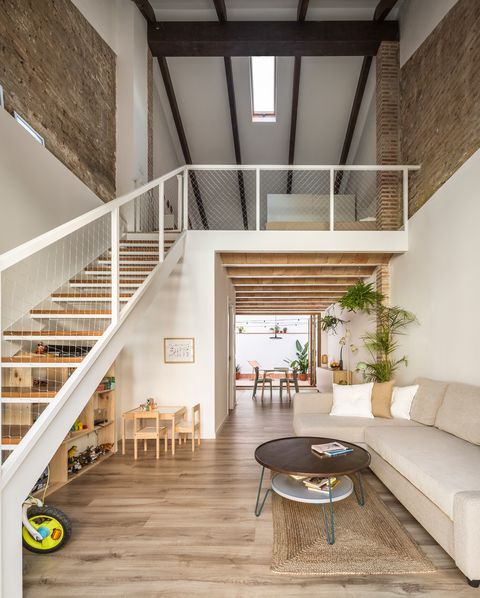 living room with double height and metal stairs