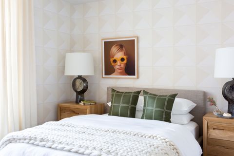 chic and feminine bedroom with wallpaper on the headboard wall