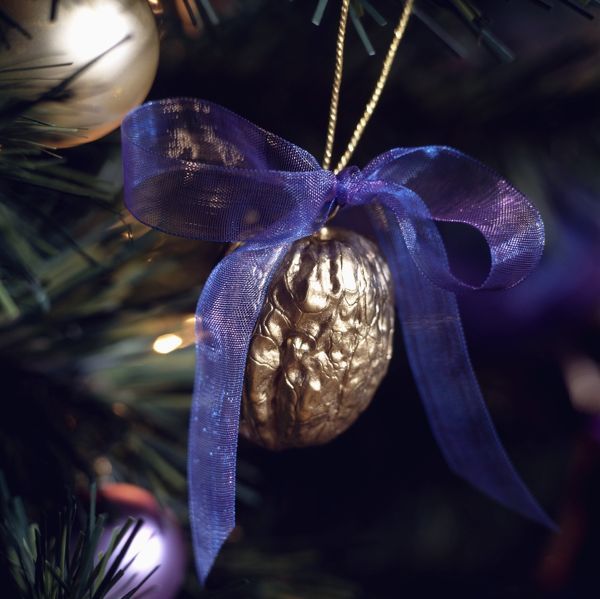 Christmas tree decoration made from a walnut sprayed gold and finished with a indigo