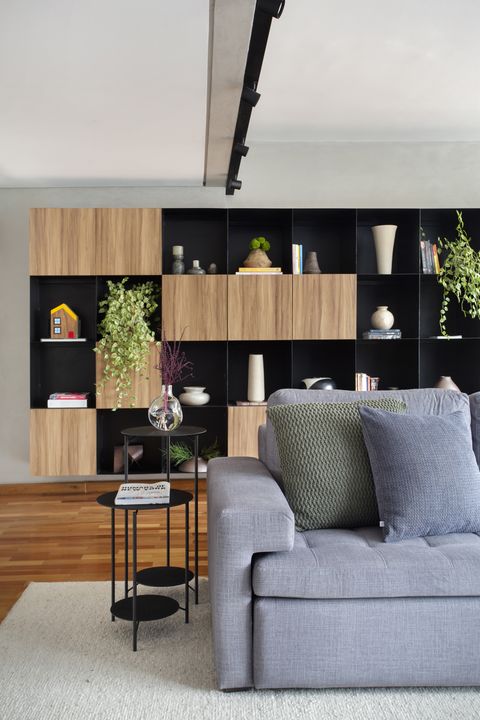 contemporary design living room with gray sofa and modular bookcase with cubes