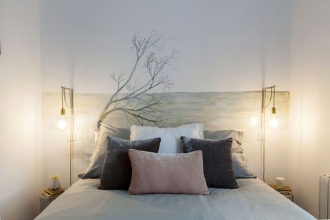 white decorated bedroom with custom headboard