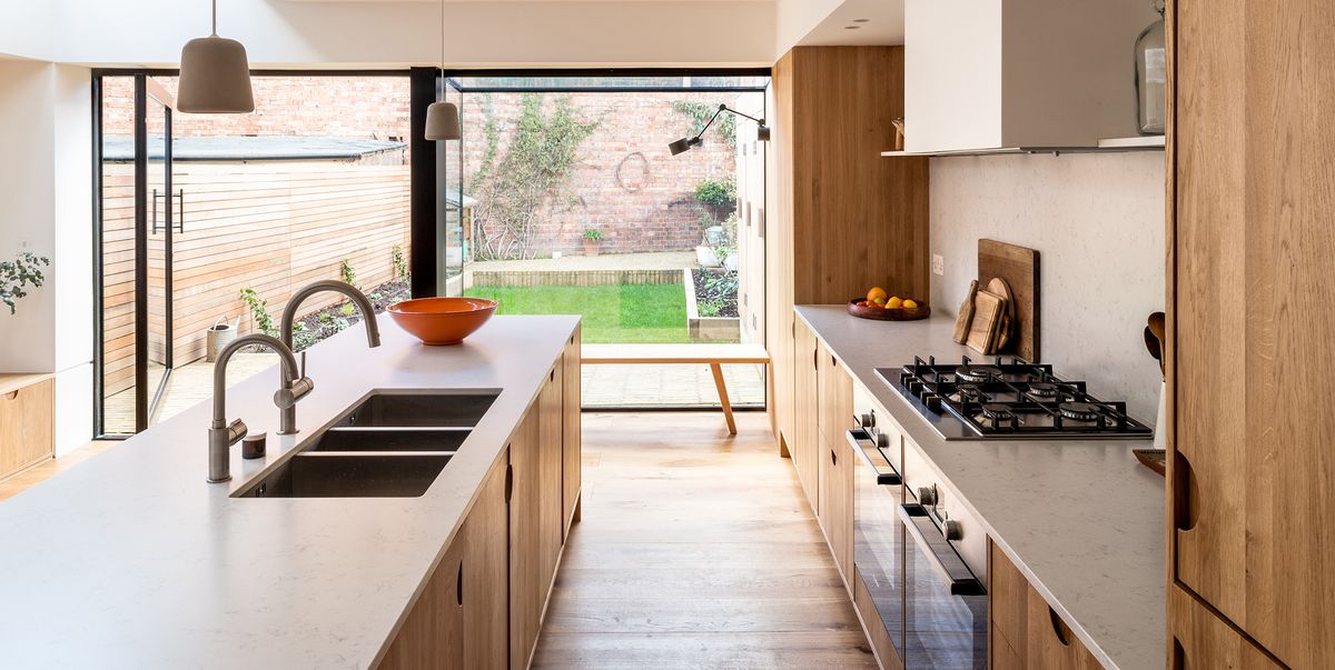 An extension with a wooden kitchen + dining room open to the garden