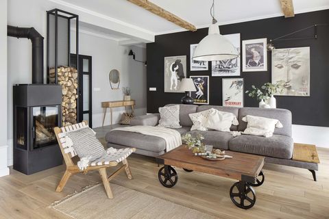 a nordic style country house living room in gray colors with an iron fireplace