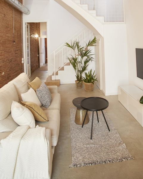 single family house project by laiaubia studio living room with exposed brick walls and white sofa